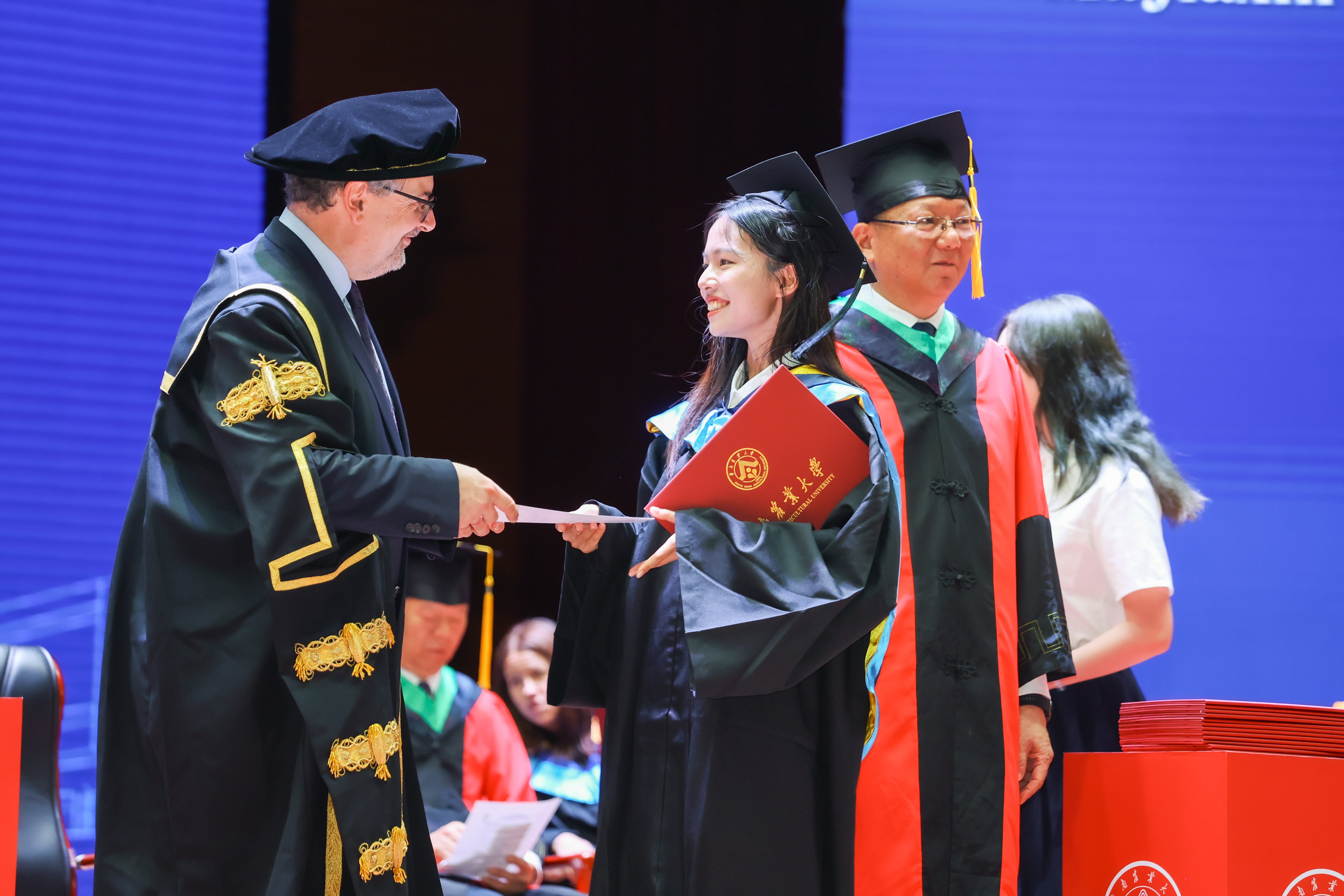 Prof Colin Scott congratulates a student