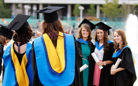 Graduates pose for a photograph at UCD.