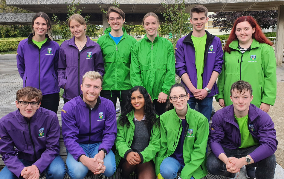 Gaeltacht UCD students standing together wearing green and purple uniforms