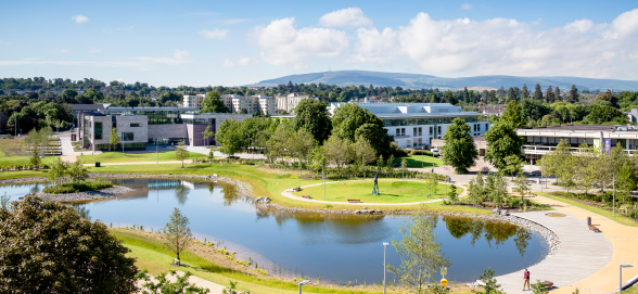 View of UCD second lake with buildings in the background on a sunny day