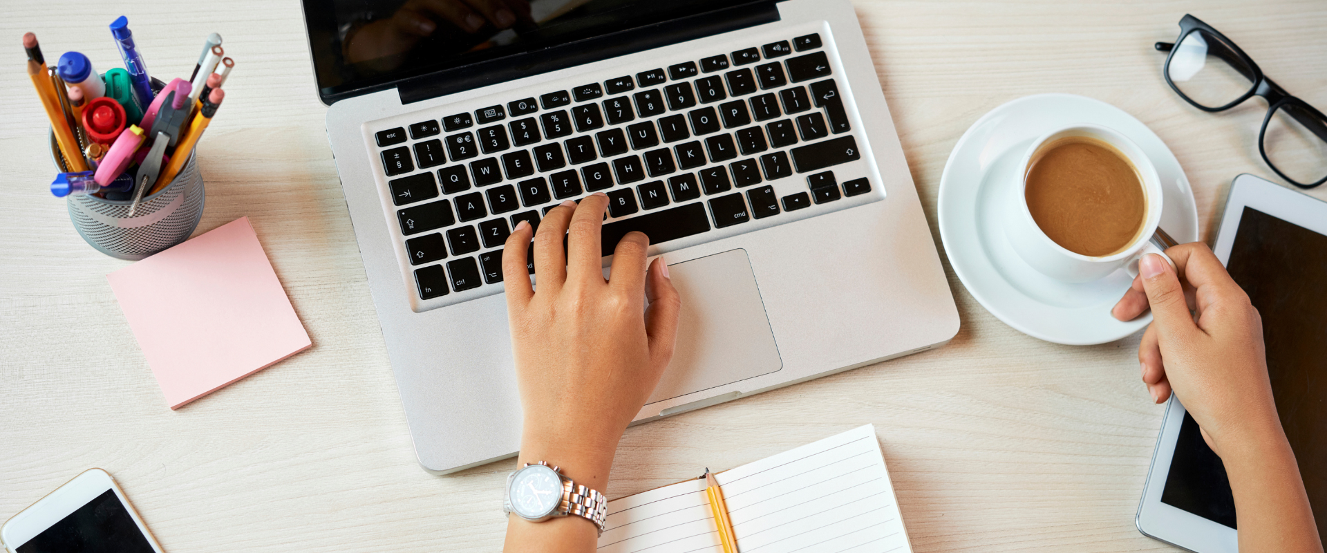 Person working on laptop with coffee