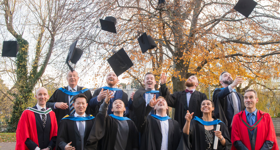 Graduating class throwing caps