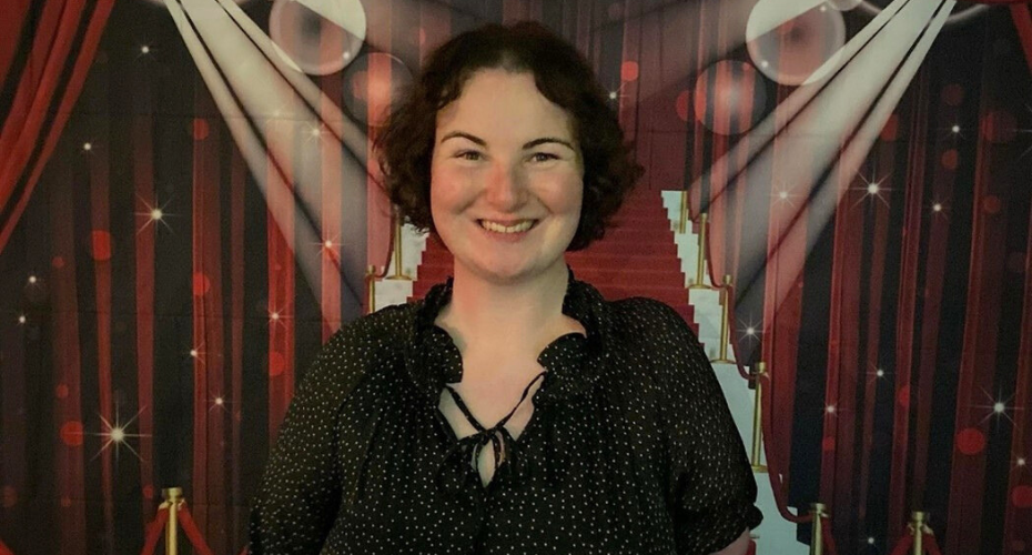 Woman with dark hair smiling to camera