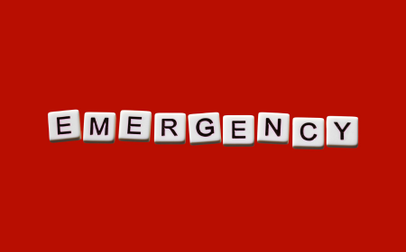 Emergency written on blocks on red background