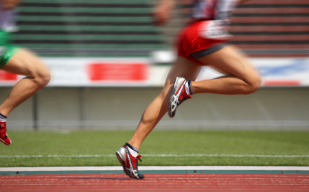 Athletes running on a running track