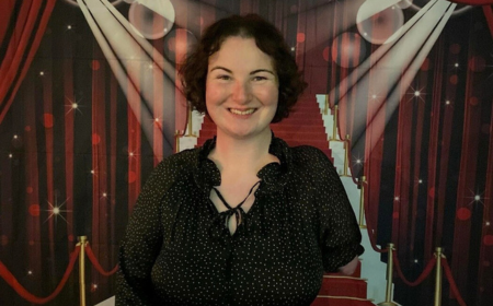 Woman with dark hair smiling to camera