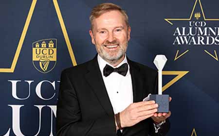 Paul Gillen holding a UCD Alumni Award