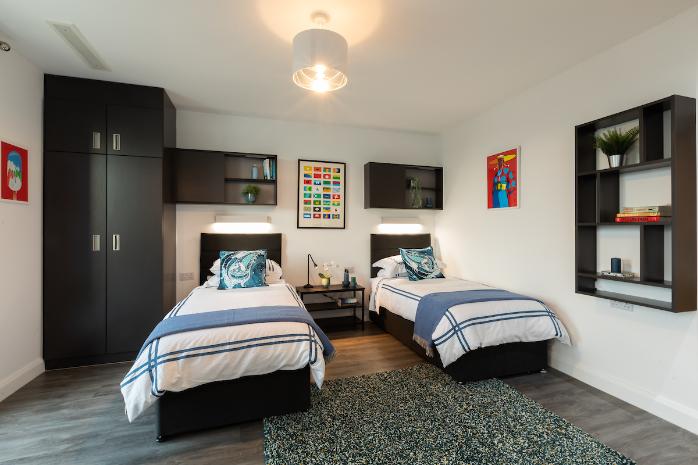 Dressed twin beds in a studio apartment of the UCD Village
