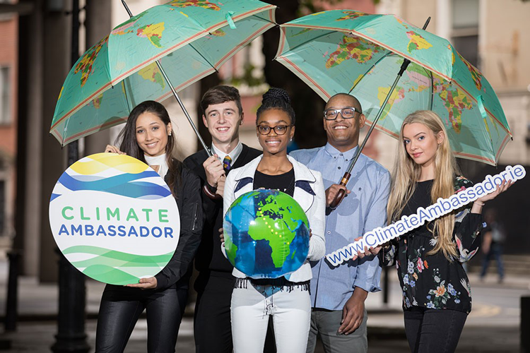 Student Climate Change Ambassadors holding a sign