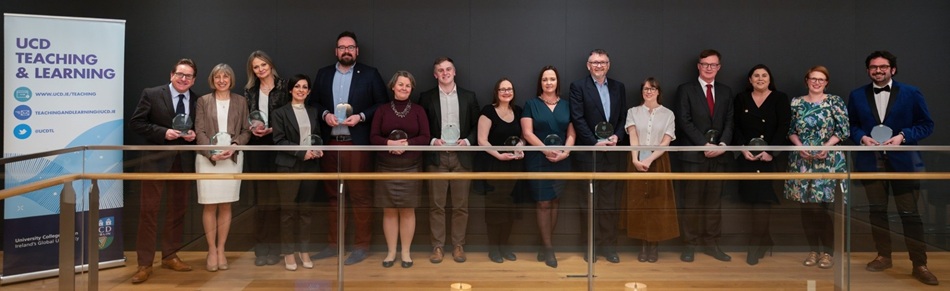 The winners of the 2023-24 UCD University Teaching and Learning Awards, standing in a line along a railing.