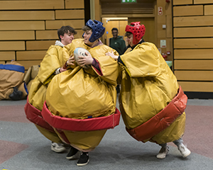 Students taking part in Dodgeball in Sumo outfits during the CHAS Sports Day