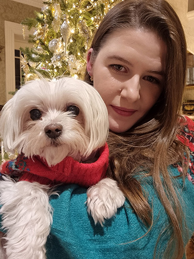 Photo of Lauren Curran holding a small white dog