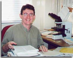 Sean Callanan, sitting at his desk in his office. 