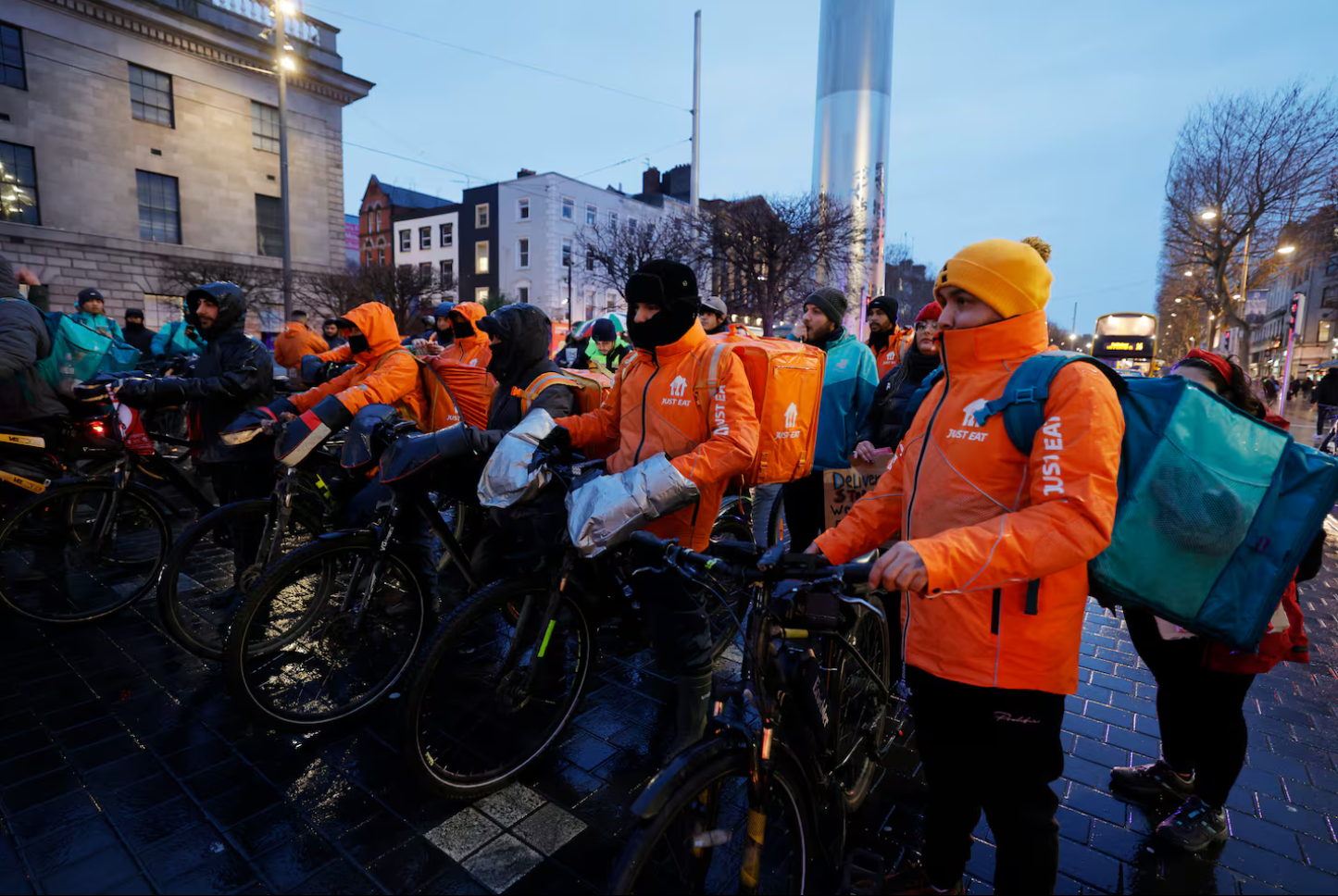 ‘Every day we have problems’: Food delivery riders protest over pay and working conditions